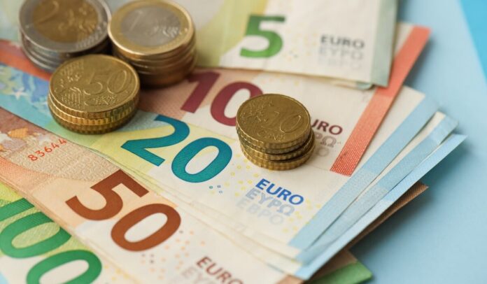 European,Union,Euro,Money,Bills,And,Coins,On,Blue,Table
